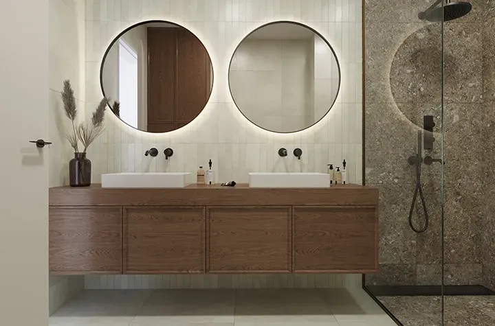 a bathroom with two sinks and a shower