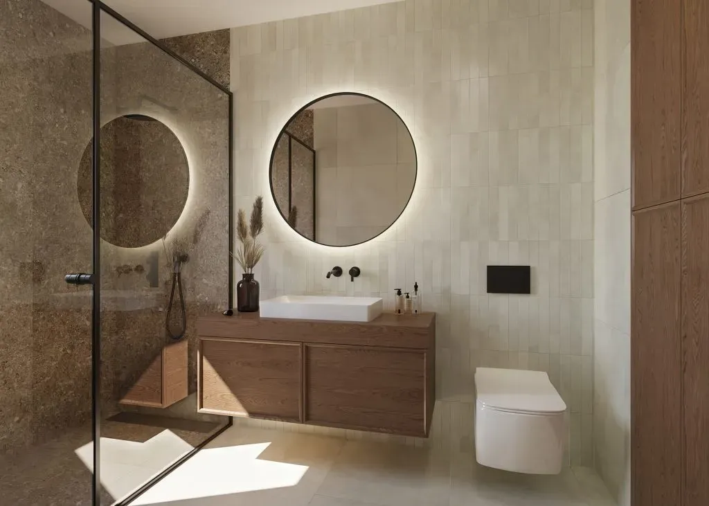 a bathroom with two round mirrors above the sink