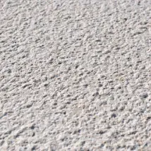 a close up of a cement surface with small rocks