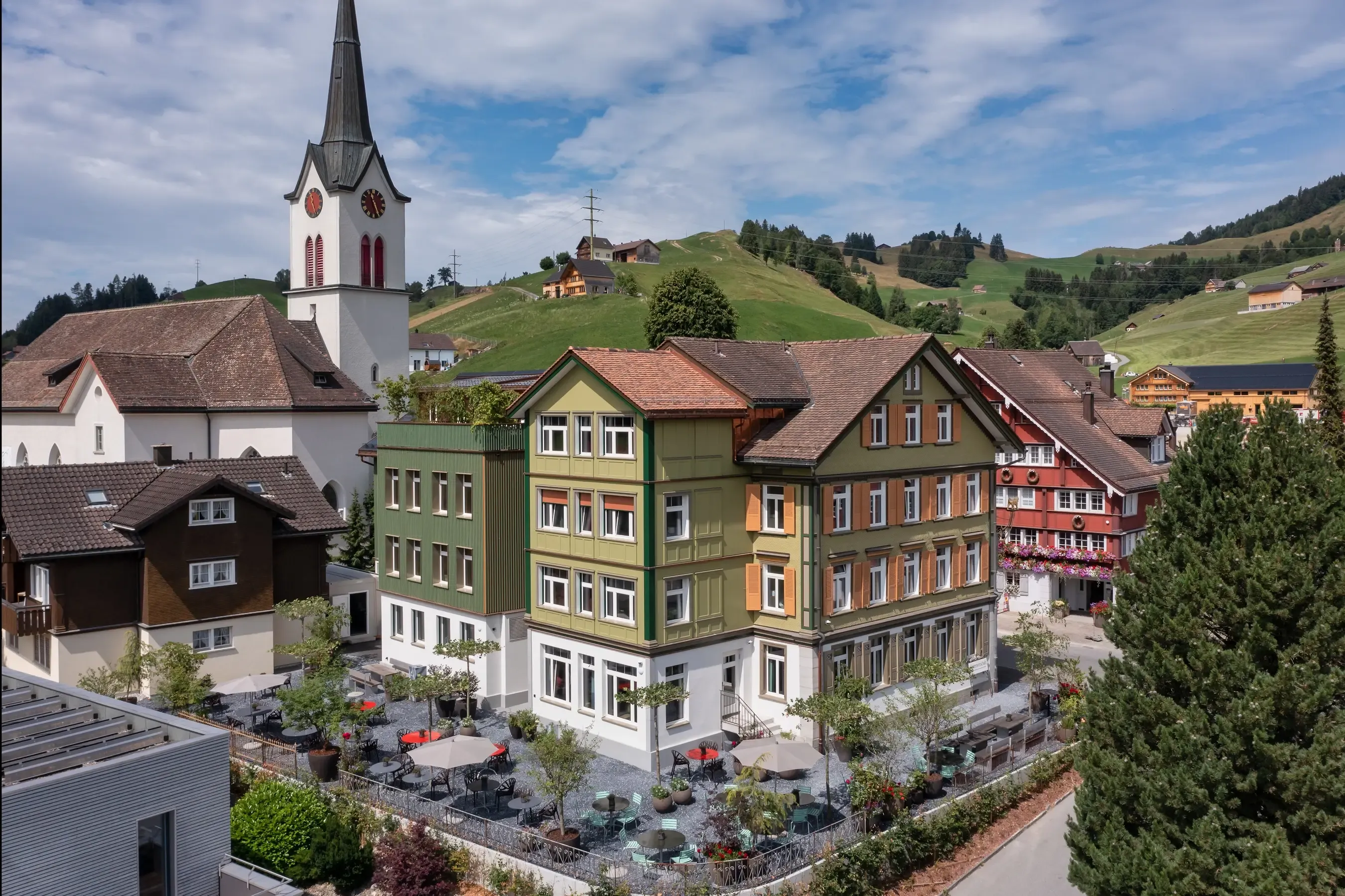 A rendering of a small town with a church on top of a hill