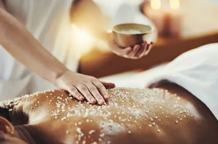 A woman getting a back massage at a spa