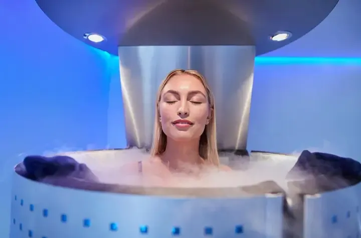 A woman in a bathtub with steam coming out of it