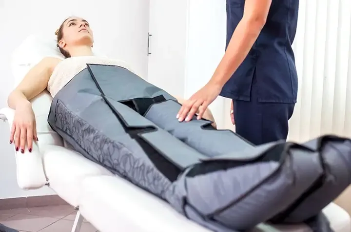 A woman getting a lymphatic pressotherapy